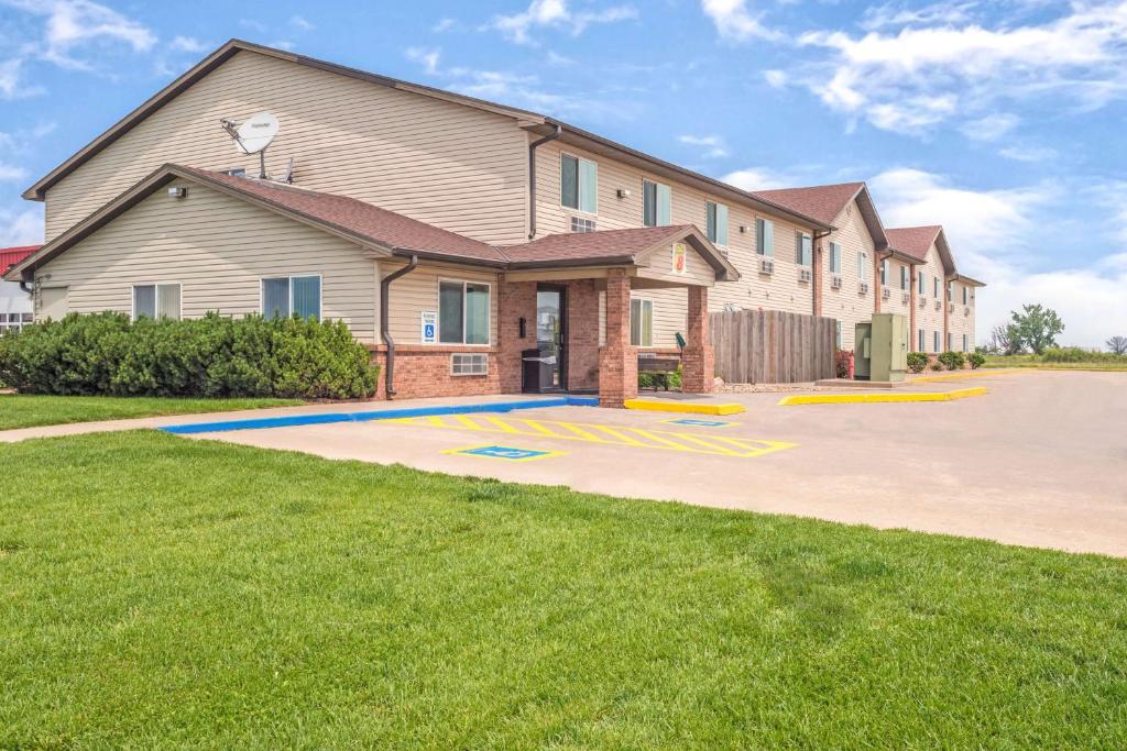 a house with a basketball court in the driveway at Super 8 by Wyndham Nebraska City in Percival