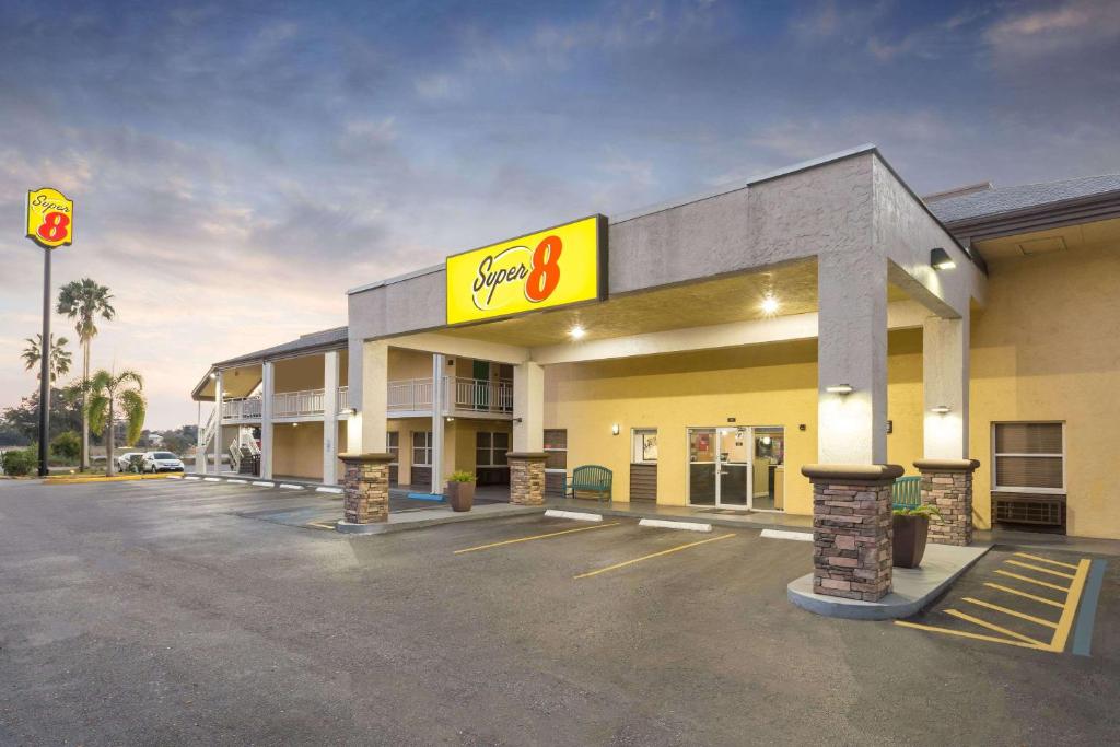 a gas station with a sign in a parking lot at Super 8 by Wyndham Ellenton Bradenton Area in Ellenton