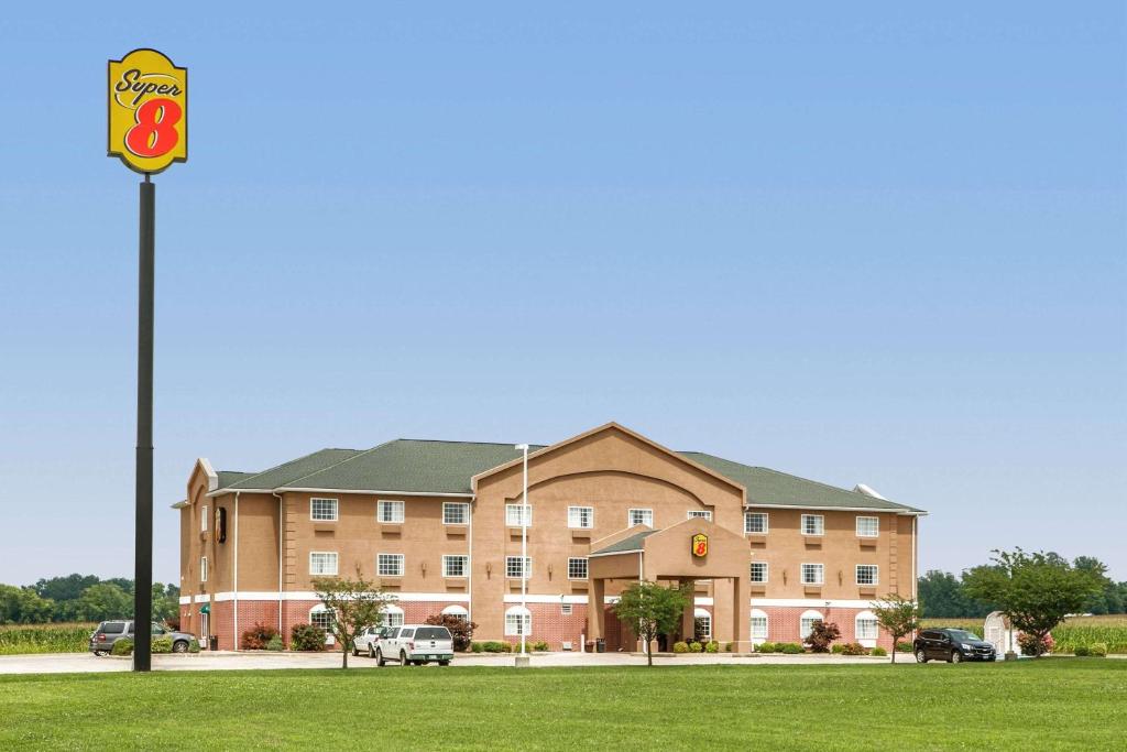 a large building with a sign in front of it at Super 8 by Wyndham Grayville in Grayville