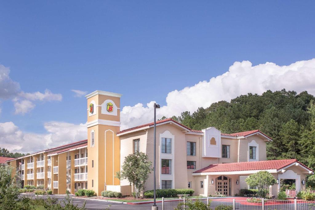 a building with a clock tower on top of it at Super 8 by Wyndham Austell/Six Flags in Austell