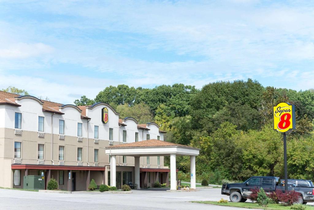 a hotel with a sign in front of a parking lot at Super 8 by Wyndham Beaver Falls in Beaver Falls