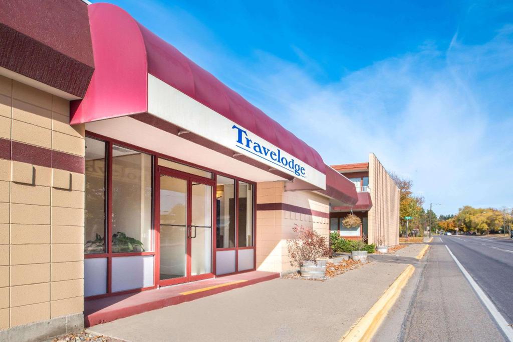 a building with a sign on the side of it at Travelodge by Wyndham Kalispell in Kalispell