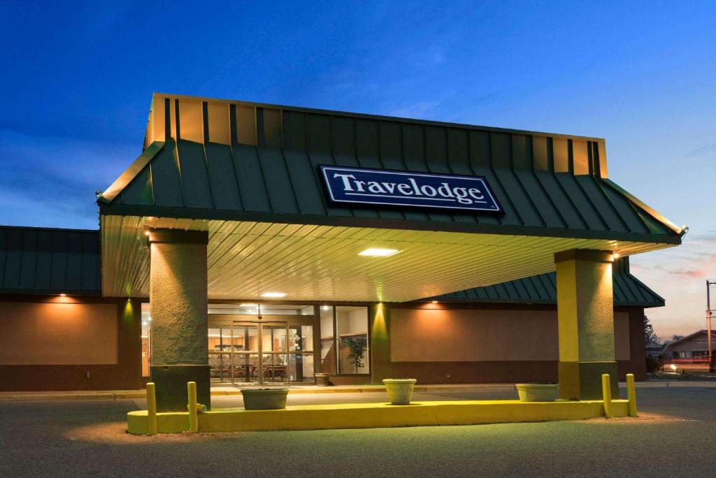 a shopping center with a sign on top of it at Travelodge by Wyndham Sturgis in Sturgis