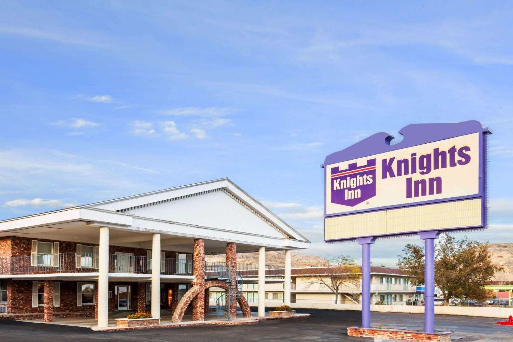 a sign in front of a kirk trusts inn at Knights Inn Wendover in Wendover