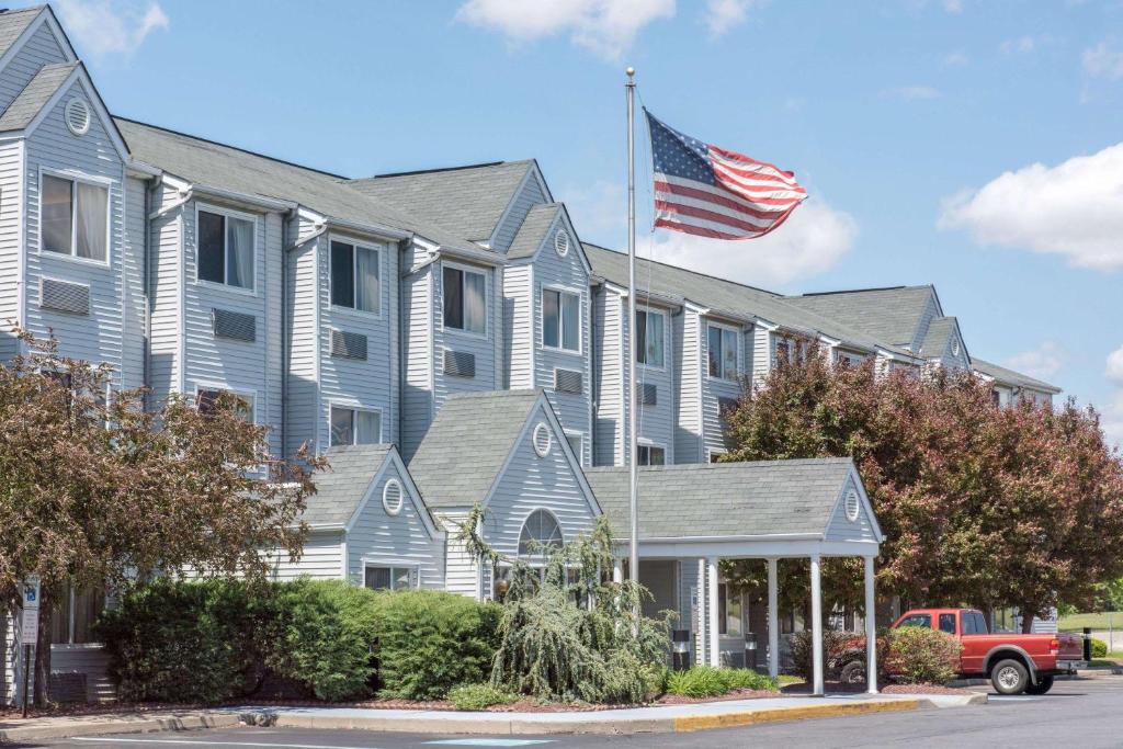 uma bandeira americana a voar em frente a uma casa em Knights Inn Allentown em Allentown