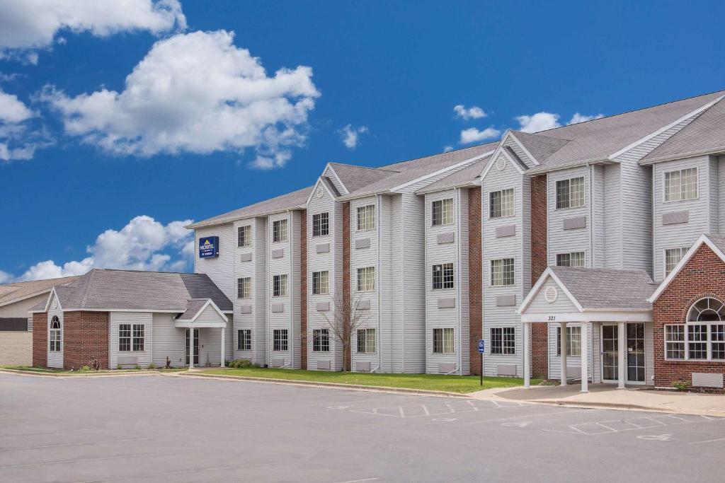 a large building with a parking lot in front of it at Microtel Inn and Suites by Wyndham Appleton in Appleton