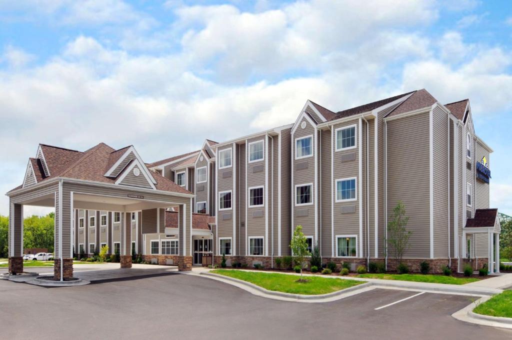 a large apartment building with a parking lot at Microtel Inn & Suites by Wyndham Marietta in Marietta