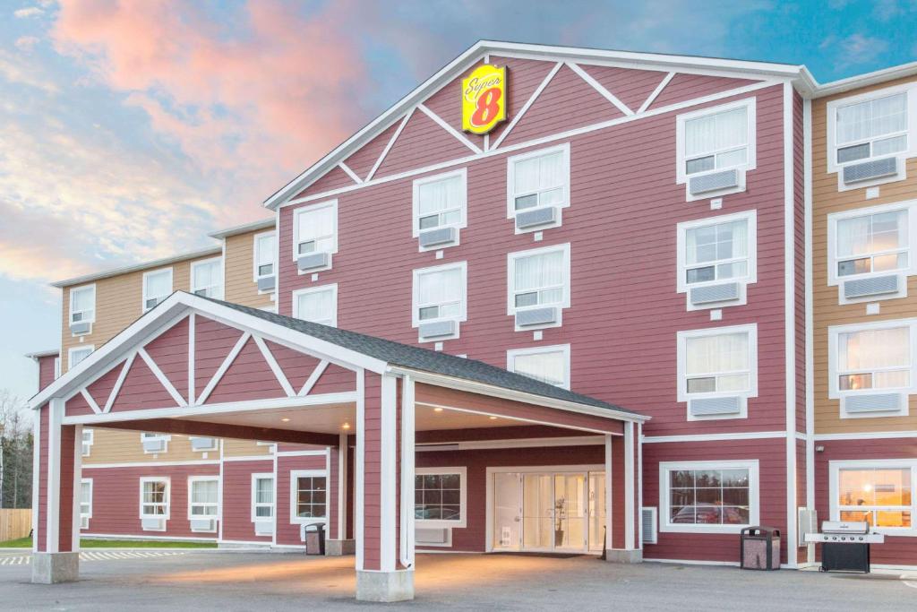 a large red building with a burger king sign on it at Super 8 by Wyndham Red Lake ON in Red Lake