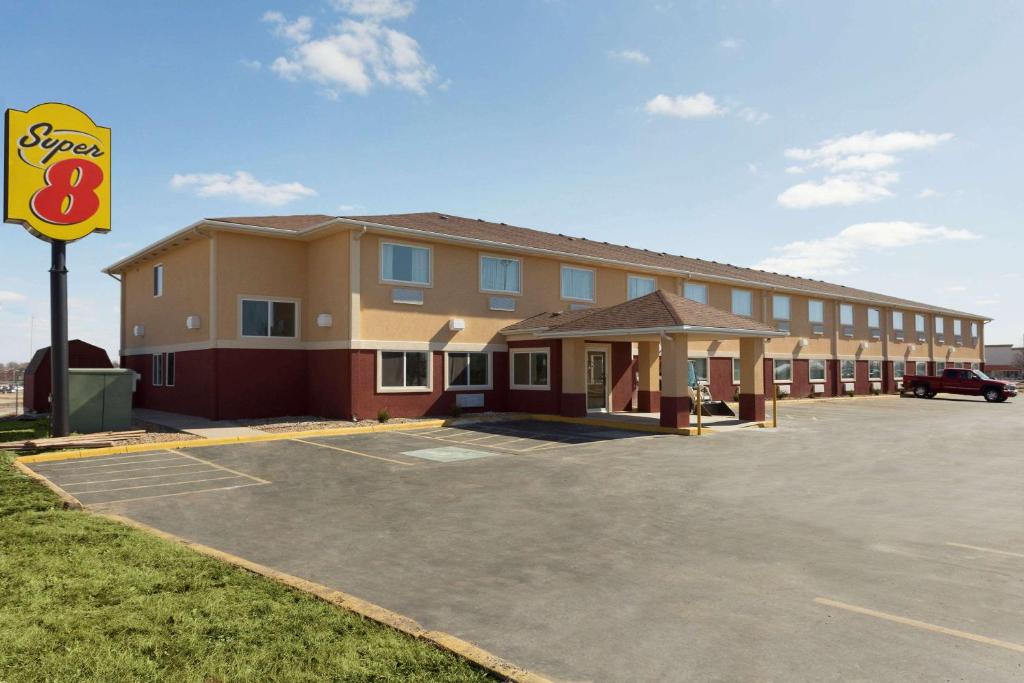 a building with a parking lot in front of it at Super 8 by Wyndham Lees Summit in Lees Summit