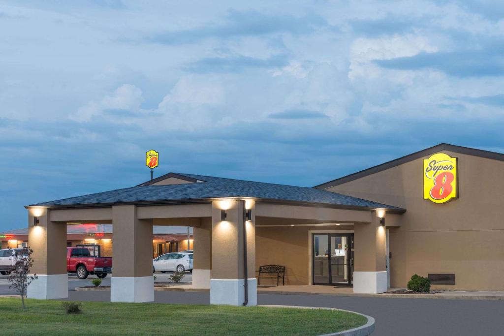 a fast food restaurant with a gas station at Super 8 by Wyndham Charleston MO in Charleston