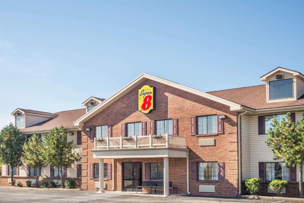 a large brick building with a hotel sign on it at Super 8 by Wyndham Madison IN in Madison