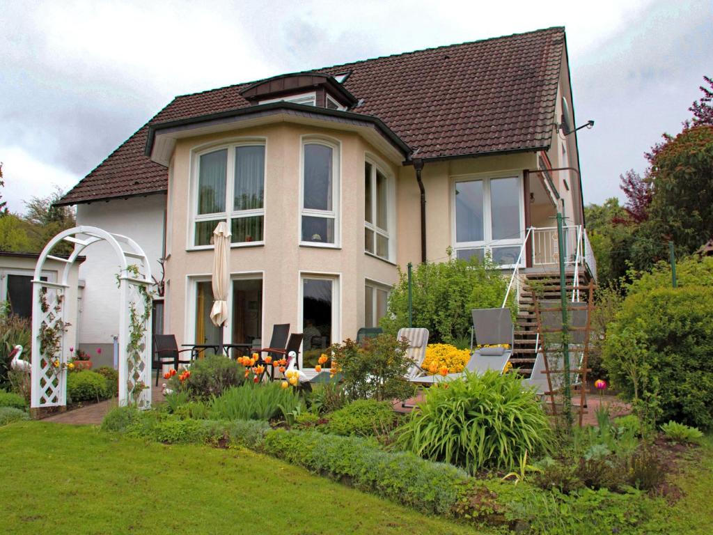 a house with a garden in front of it at Attractive apartment in Bellenberg with garden in Horn-Bad Meinberg
