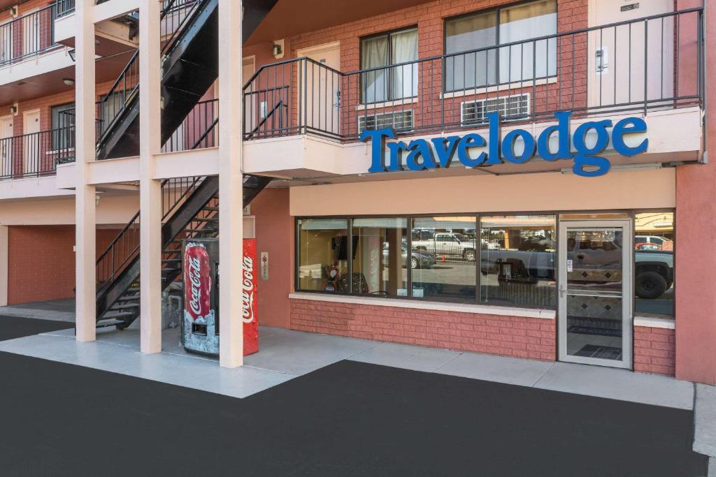 a travelodge building with a sign on the front of it at Travelodge by Wyndham Reno in Reno