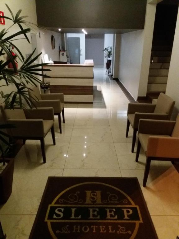a waiting room with chairs and a sign on the floor at Sleep Hotel in Toledo
