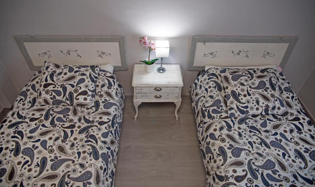 ein Schlafzimmer mit 2 Betten und einem Nachttisch mit einer Schublade in der Unterkunft Piso Pirineos in Jaca
