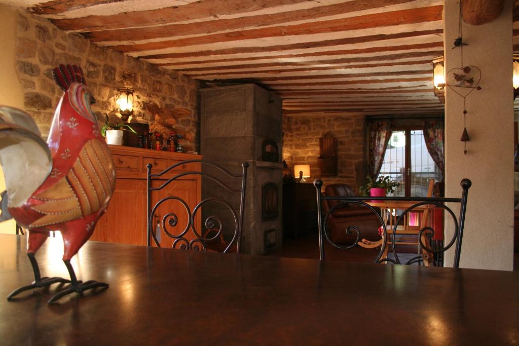 a kitchen with a table with a chicken statue on it at Chambre d'hôtes l'Etoile du Berger in Arbois