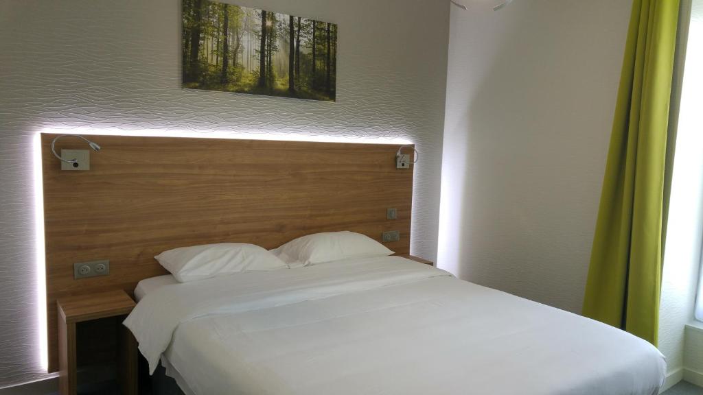 Postel nebo postele na pokoji v ubytování Hôtel Le Verger