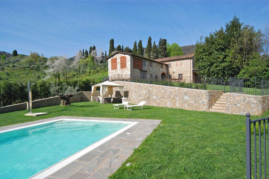 einen Hinterhof mit einem Pool und einem Haus in der Unterkunft Montefiore in Lucca