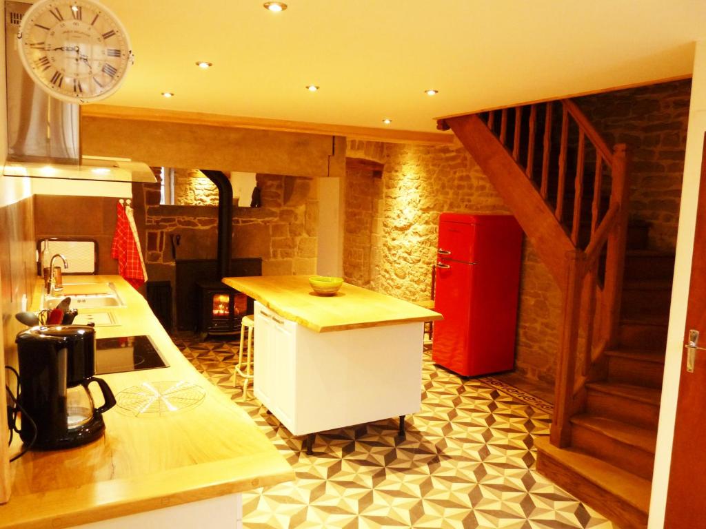 a kitchen with a counter and a red refrigerator at Chez Henriette in Voiteur