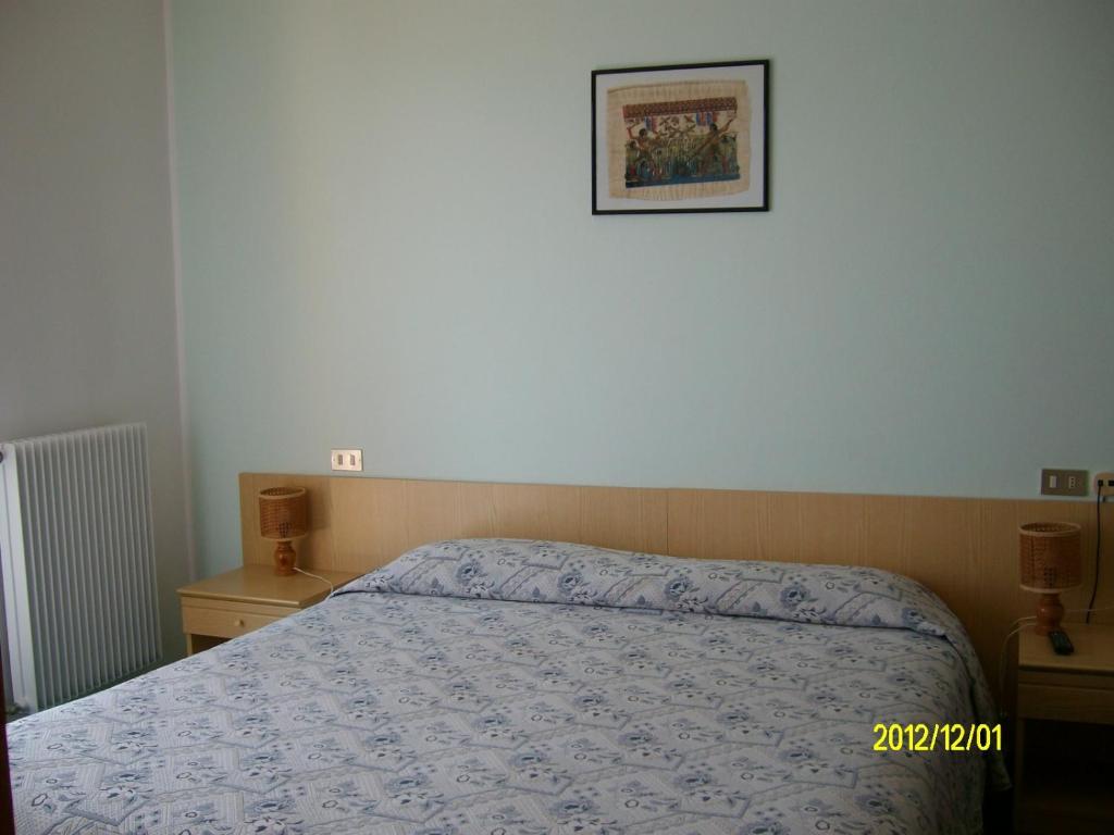 Postel nebo postele na pokoji v ubytování Albergo Genzianella