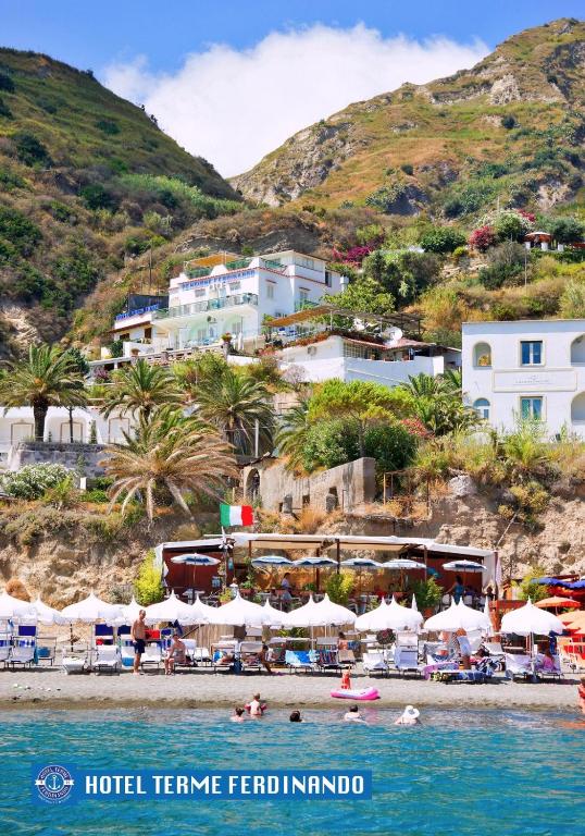 a group of people in the water at a beach at Hotel Ferdinando Beach & Thermal Spa in Ischia