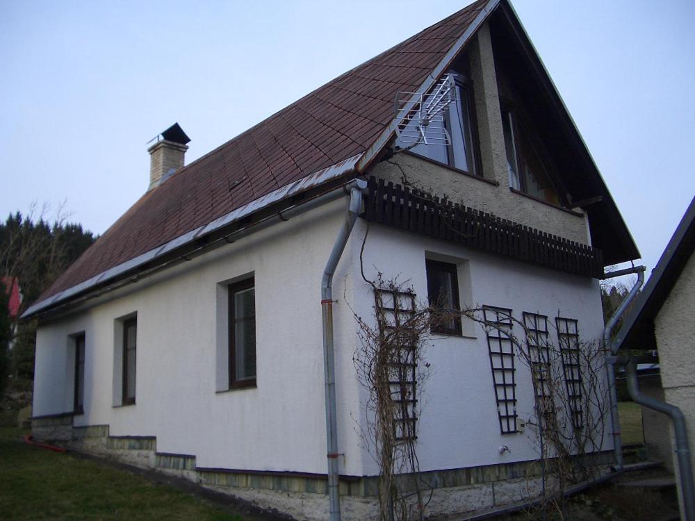 an old white house with a brown roof at Chata Pavla in Jablonec nad Nisou