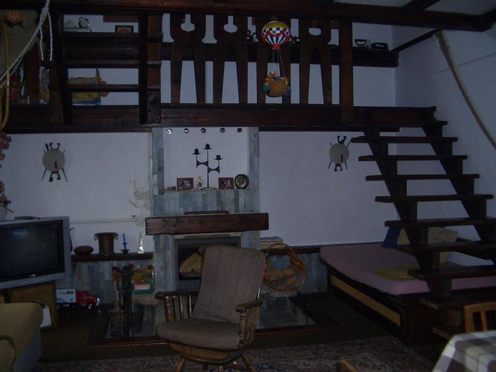 un soggiorno con scala a chiocciola e sedia di Chata Pavla a Jablonec nad Nisou