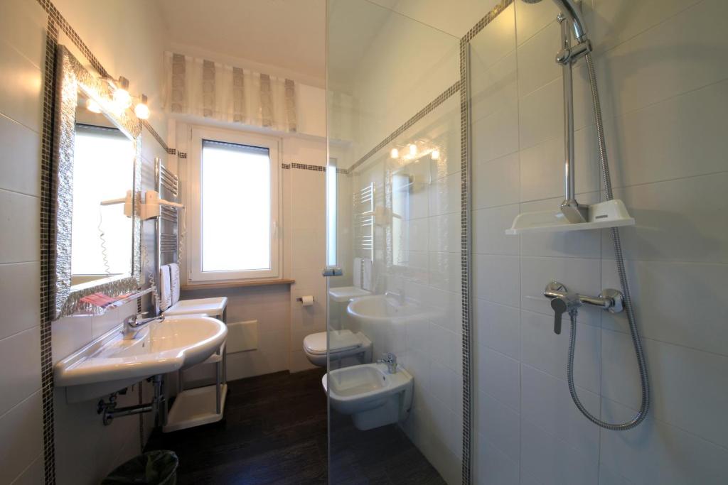a bathroom with a shower and a sink and a toilet at B&B Al Picchio in Monopoli