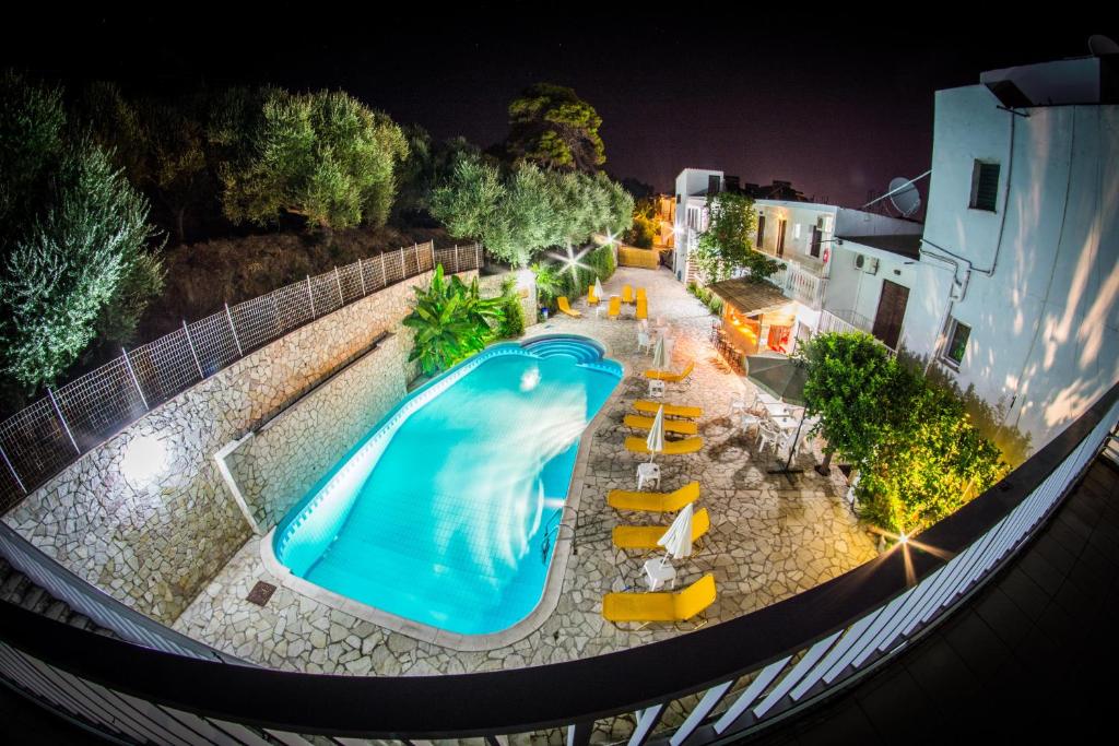 an overhead view of a swimming pool at night at Panorama in Laganas