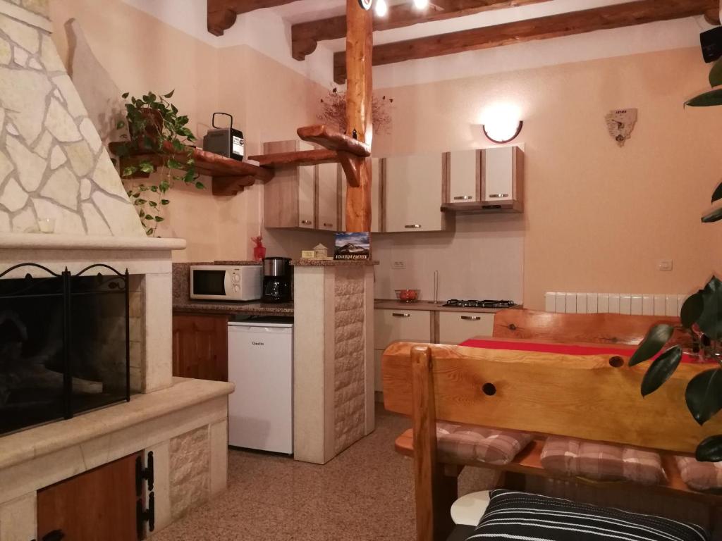 a kitchen with a fireplace and a stove top oven at Apartman Fachin in Motovun