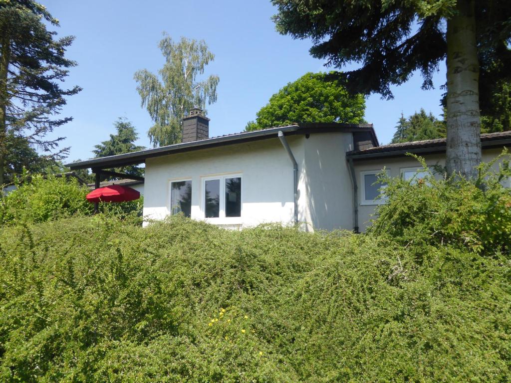 a white house with a red roof at Ferienhaus Eifelurlaub in Biersdorf