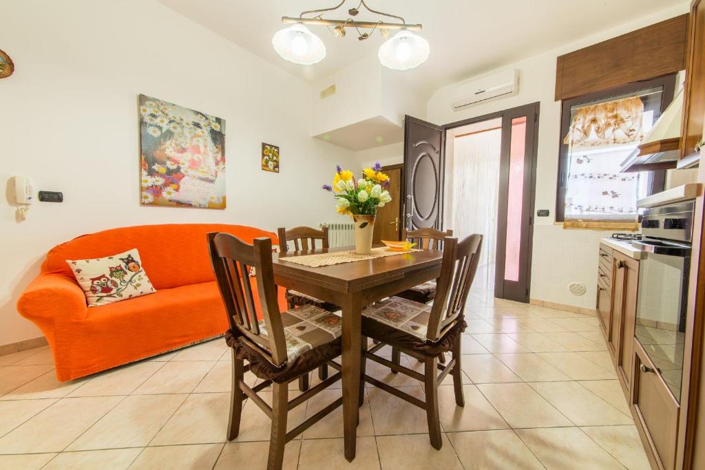 a living room with a dining room table and a couch at Salento Sweet Home in Melissano
