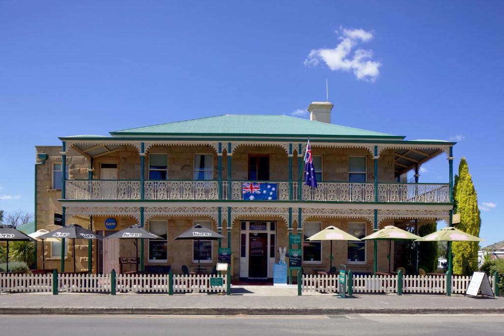 a large building with umbrellas in front of it at The Richmond Arms Hotel in Richmond