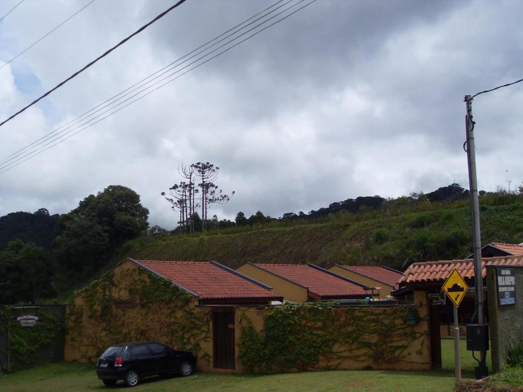 a house with a car parked in front of it at Hospedaria Vila Khepri in Gonçalves