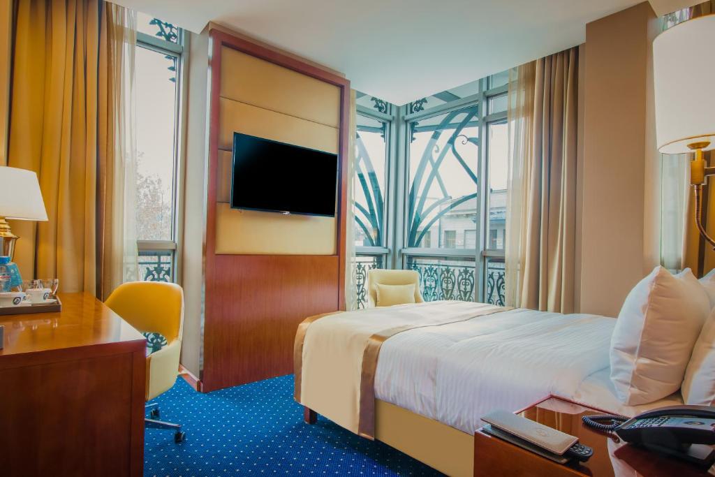 Postel nebo postele na pokoji v ubytování New Tiflis Hotel