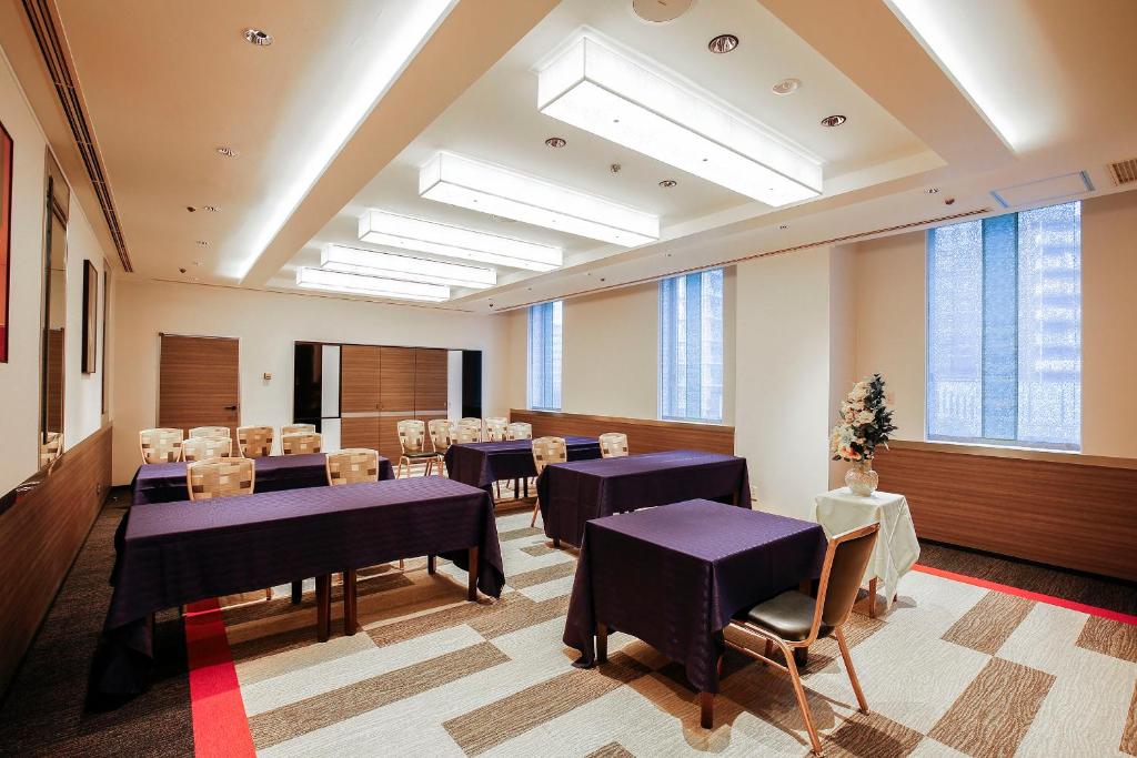 a conference room with tables and chairs and windows at New Otani Inn Tokyo in Tokyo
