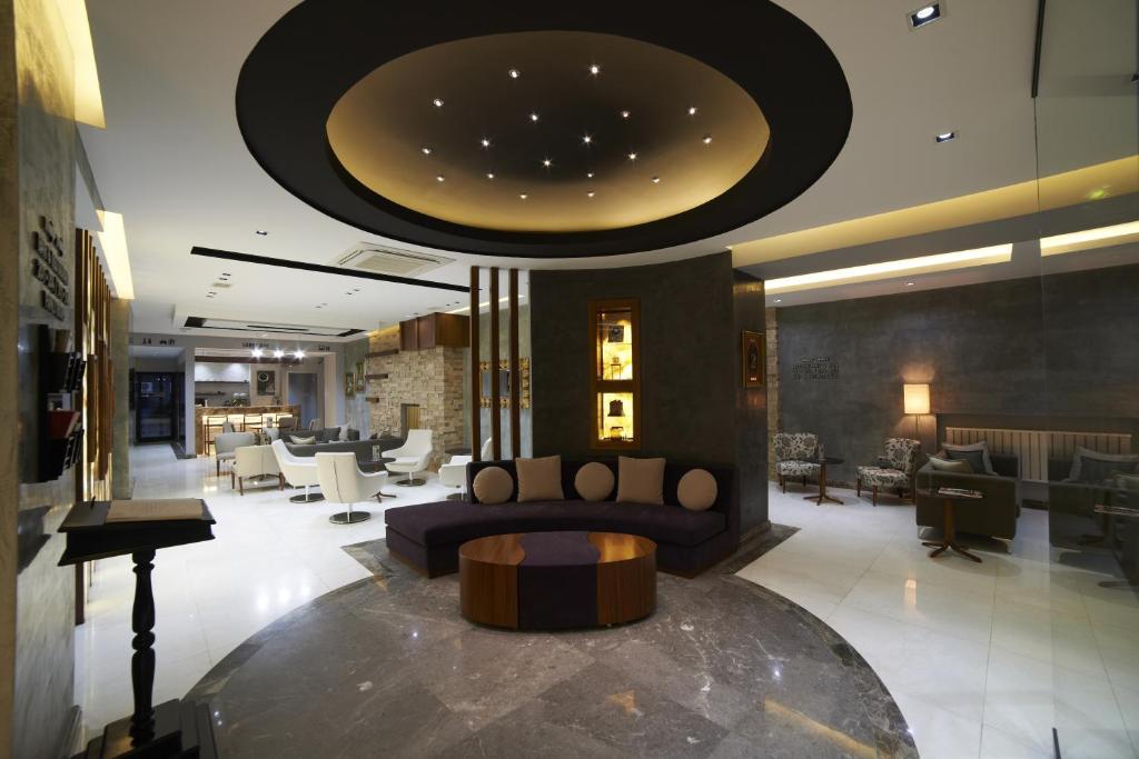 a lobby of a hotel with a couch and chairs at Soyic Hotel in Eskisehir