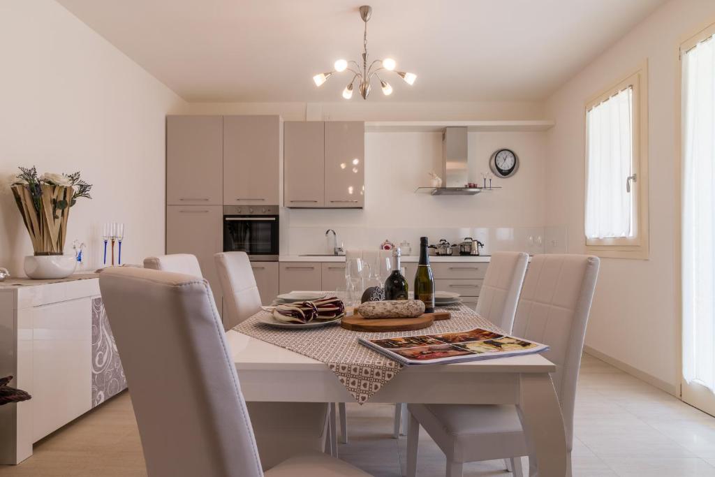 Stabiuzzo的住宿－Cimadolmo Prosecco And History，白色的厨房配有桌椅和用餐室