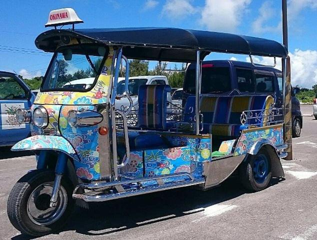 a small golf cart parked in a parking lot at Taketomijima Akaneya in Taketomi