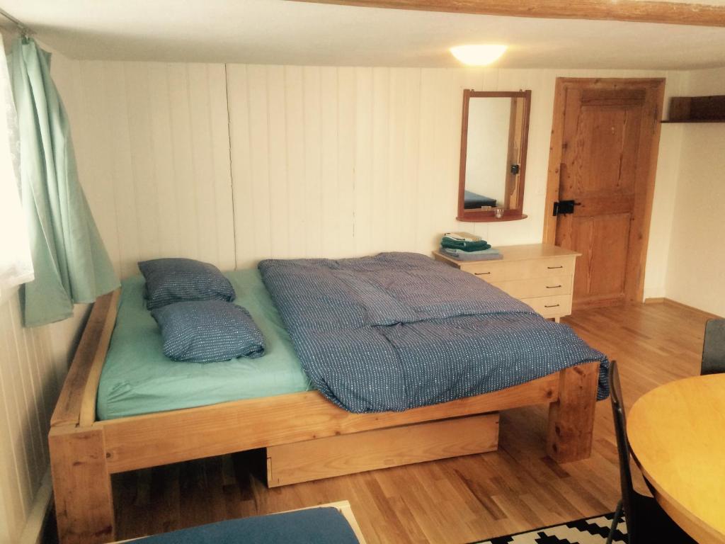 a bedroom with a bed with two pillows on it at Im Dorf - Central in Herisau
