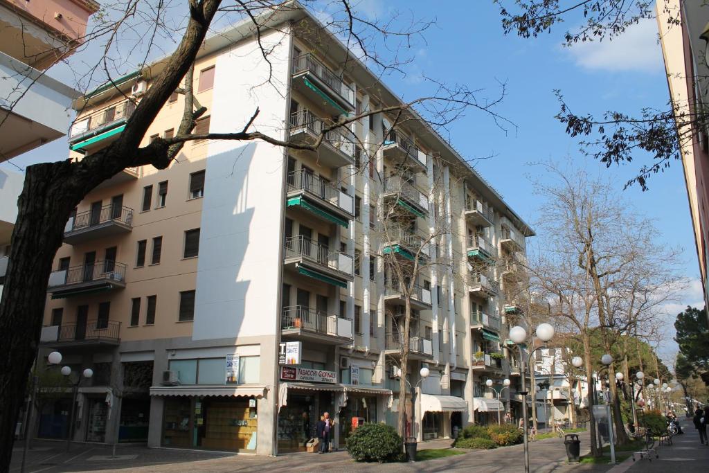 a tall white building on a city street at Santis 44 in Grado