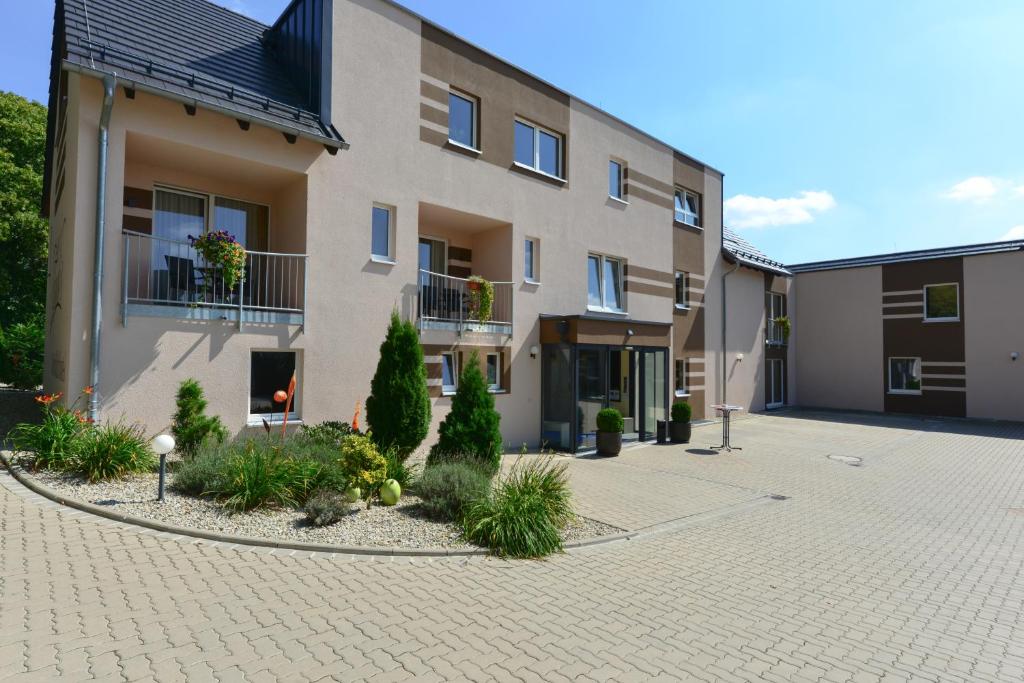 a building with a courtyard in front of it at Schade's Wohlfühlhotel in Selb