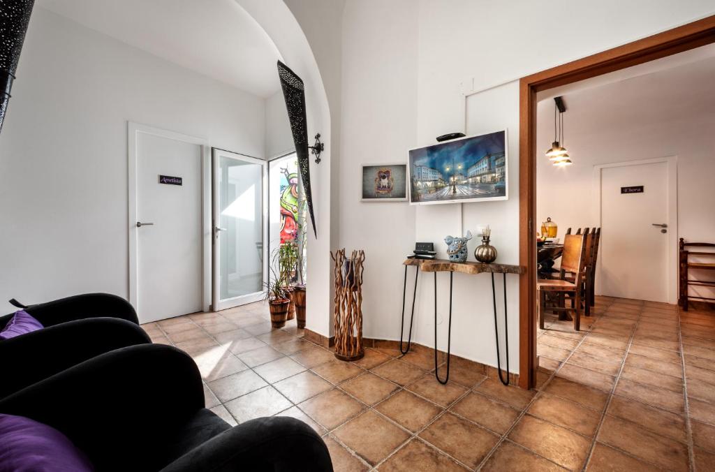 a living room with a couch and a table at Peacock House in Évora