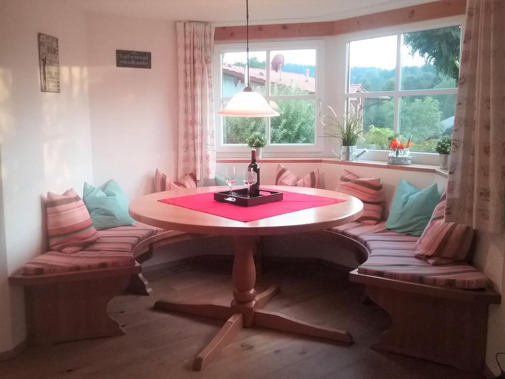 a table and chairs in a room with a window at HOME4GOLF Uttlau in Bad Griesbach
