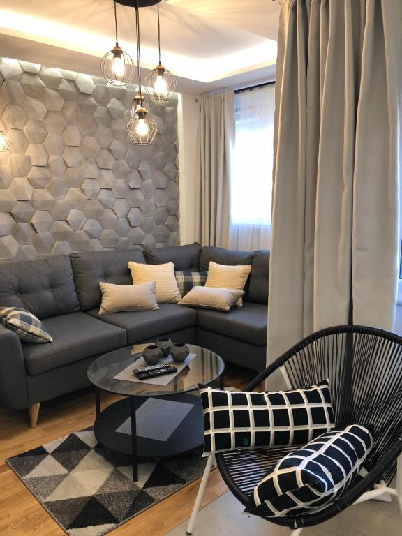a living room with a couch and a table at Family & Business Sauna Apartments Rynek Centrum Downtown - 2 Bedroom with Private Sauna, Balcony, Parking in Kielce