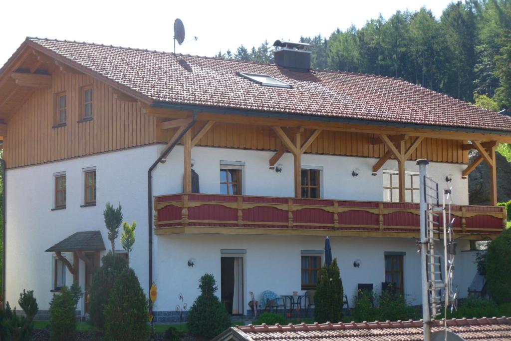 a large white house with a wooden roof at Haus Ellerbeck in Bodenmais