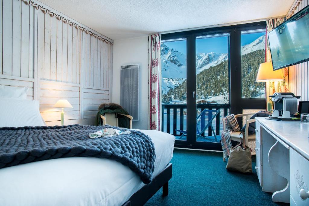 Postel nebo postele na pokoji v ubytování Lake Hotel Courchevel 1850