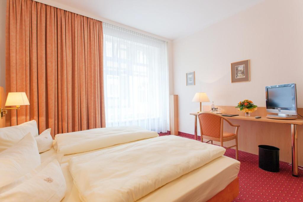 Postel nebo postele na pokoji v ubytování Hotel Benn