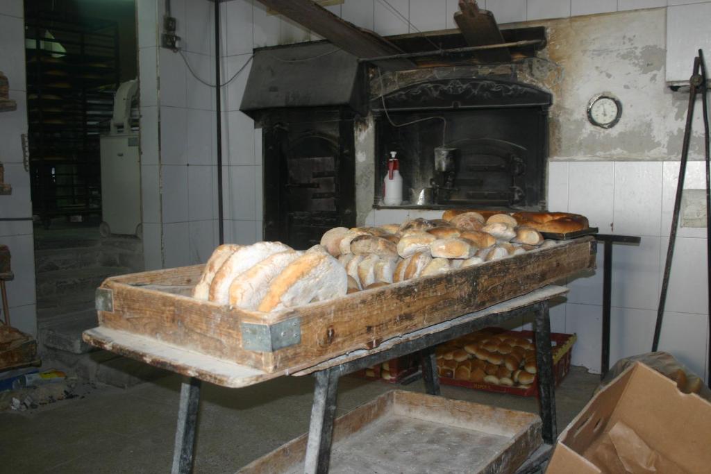 a pile of loaves of bread sitting on top of an oven at Pretty Bay Apartments in Birżebbuġa