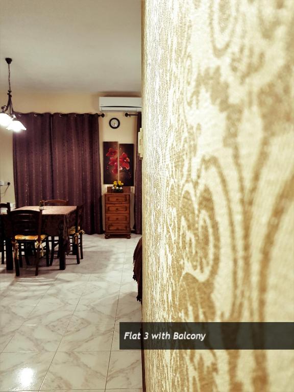 a room with a table and a dining room at Pretty Bay Apartments in Birżebbuġa